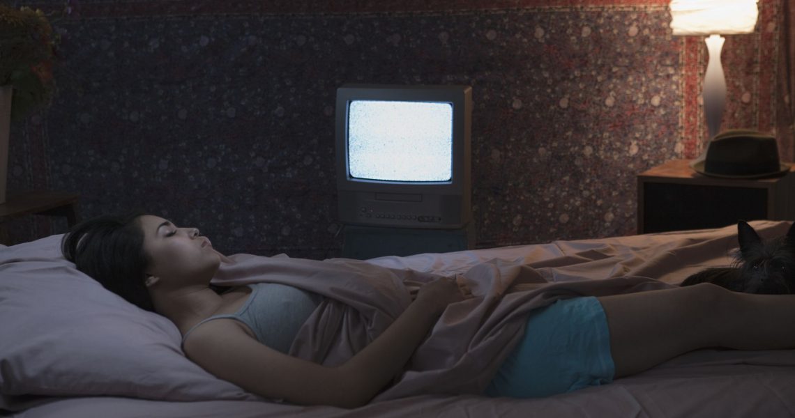 donna dorme con tv acceso